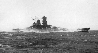 煙を上げて航行する旧日本海軍の戦艦の白黒写真