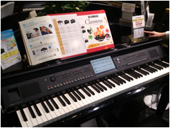 パンフレットが置かれたヤマハ電子ピアノ「クラビノーバ」の店頭展示