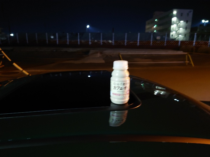 夜、車のトランクの上に置かれた薬瓶の写真
