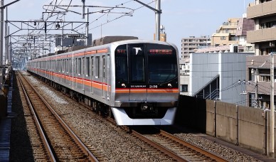 高架線路を走るオレンジ色の電車